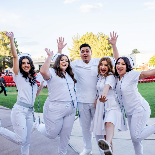 five students jumping for joy