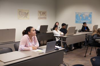 image of student sitting at a laptop