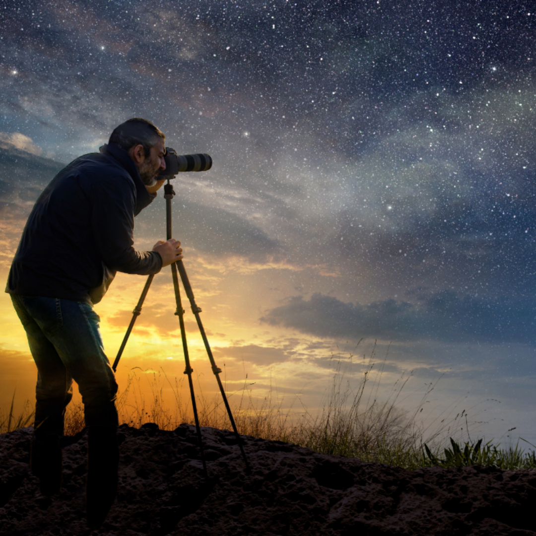 Man looking at the stars through telesdcope