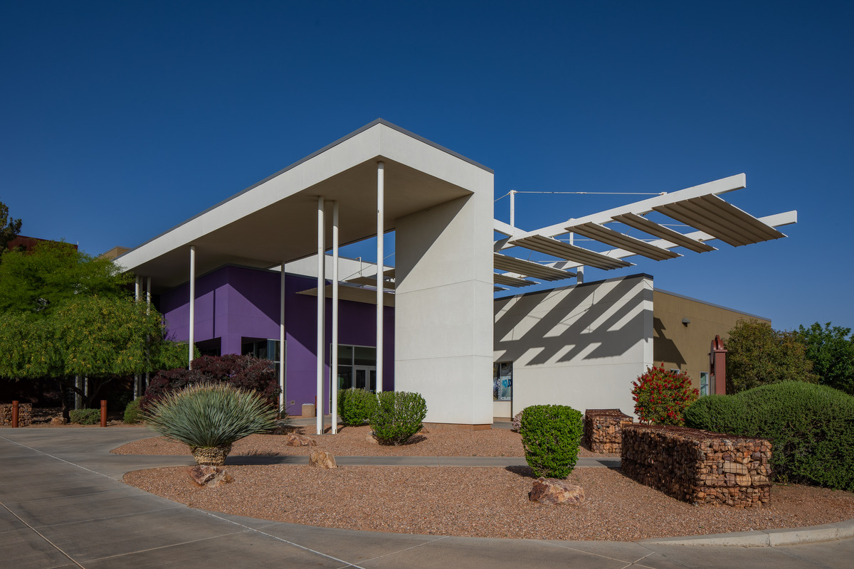 Front entrance to new building. Modern architecture with glass doors and tall windows.