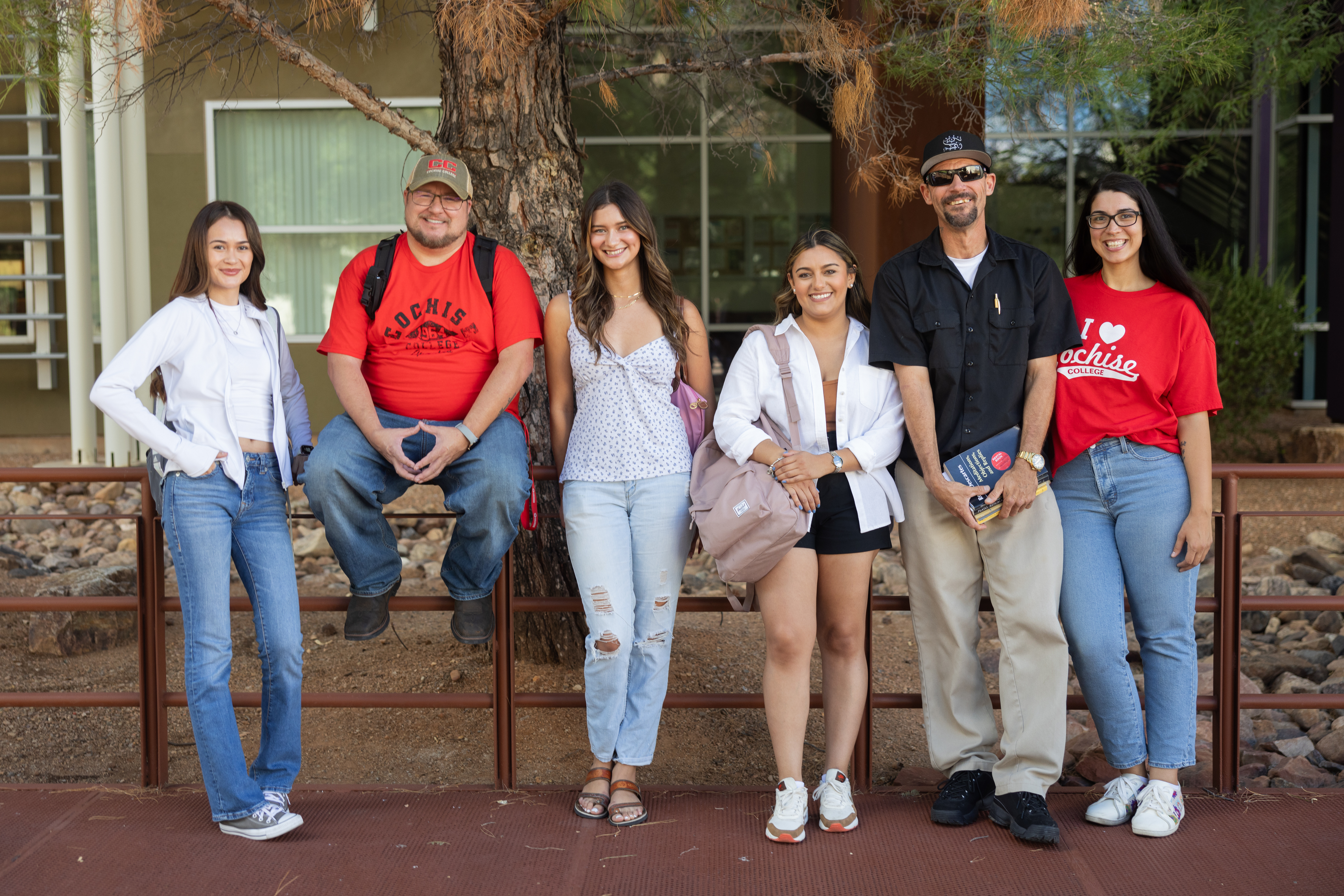 Group of Cochise College students smiling outdoors on the Sierra Vista campus.