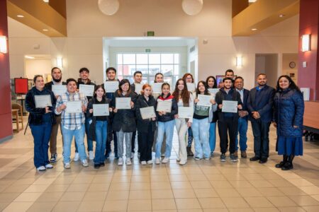 Students with professors holding certificate of participation